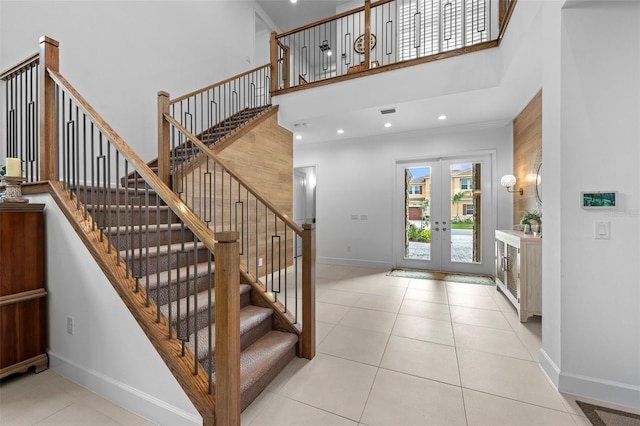 tiled entryway featuring french doors and a high ceiling