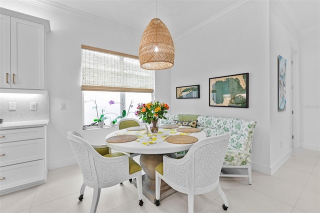 dining space featuring ornamental molding and light tile patterned floors