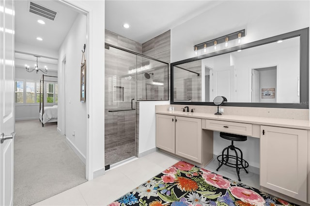 bathroom with vanity, an enclosed shower, tile patterned flooring, and a notable chandelier