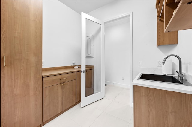 kitchen featuring light tile patterned flooring and sink