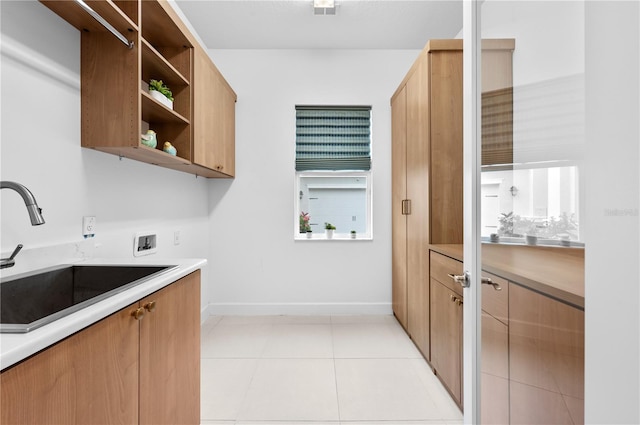 kitchen with sink and light tile patterned floors