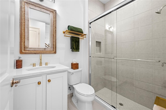 bathroom featuring vanity, an enclosed shower, and toilet