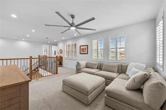 living room featuring ceiling fan and light carpet