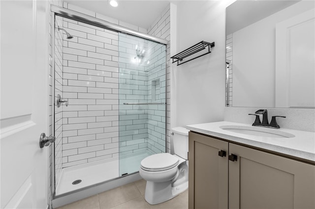 bathroom with walk in shower, tile patterned floors, vanity, and toilet