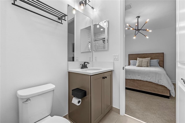 bathroom featuring vanity, tile patterned floors, and toilet