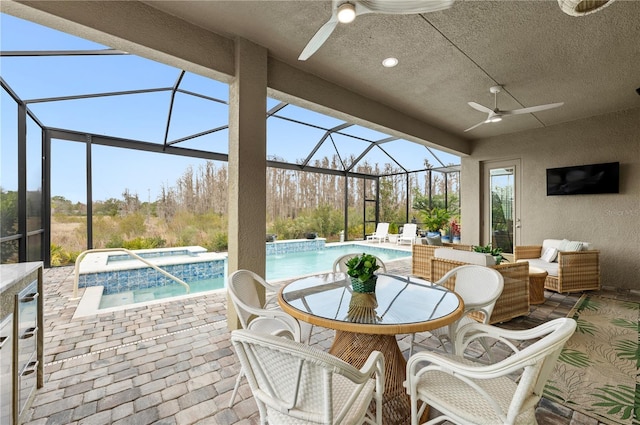 view of patio featuring a swimming pool with hot tub, an outdoor hangout area, ceiling fan, and glass enclosure