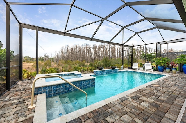 view of swimming pool with an in ground hot tub, a patio area, and glass enclosure