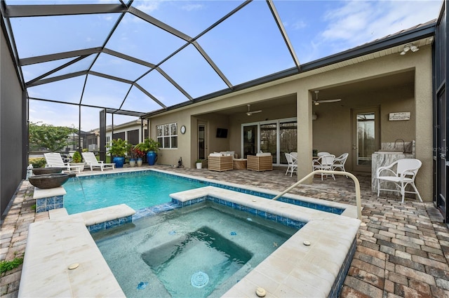 view of swimming pool with a lanai, an in ground hot tub, ceiling fan, an outdoor living space, and a patio