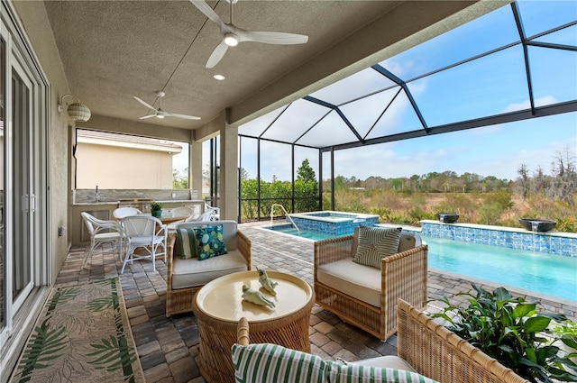 view of patio featuring outdoor lounge area, sink, a pool with hot tub, ceiling fan, and glass enclosure