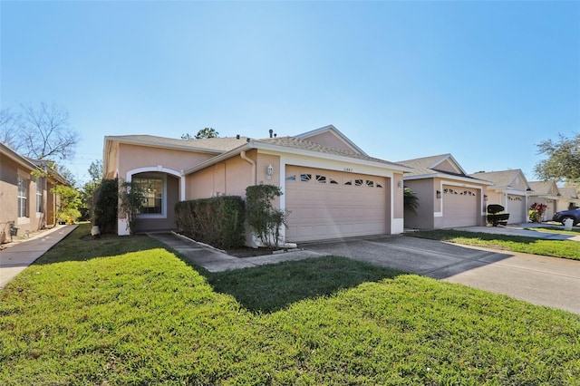 single story home featuring a garage and a front lawn