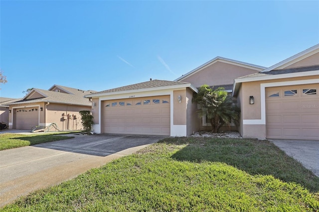 ranch-style house with a garage and a front yard