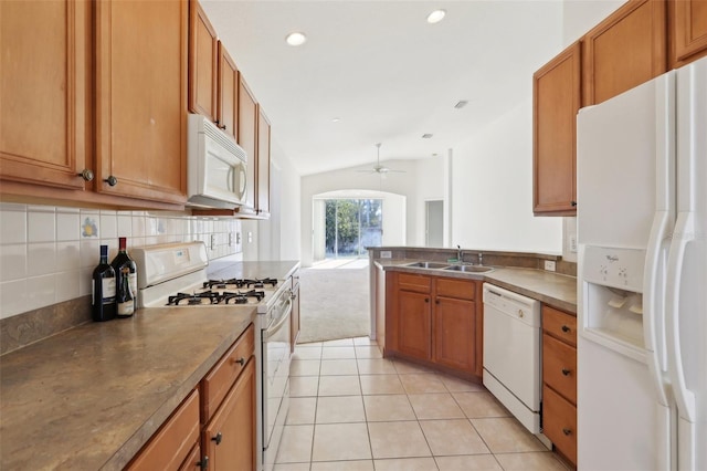 kitchen with white appliances, ceiling fan, sink, light tile patterned floors, and lofted ceiling