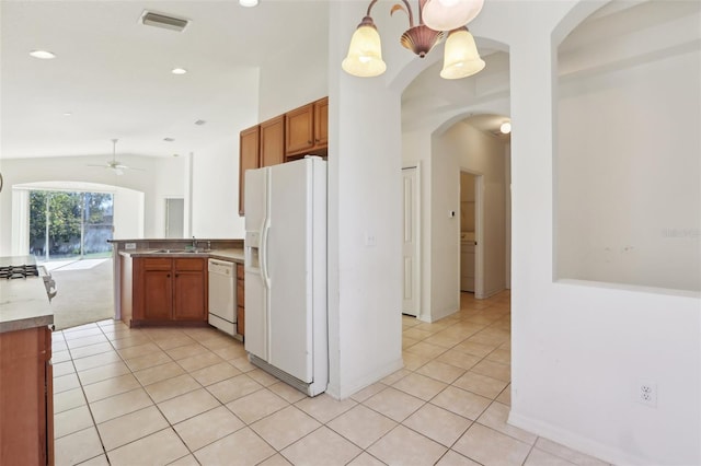 kitchen featuring ceiling fan, hanging light fixtures, kitchen peninsula, lofted ceiling, and white appliances