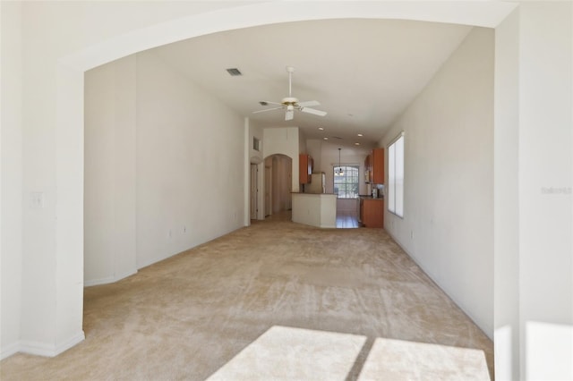 carpeted spare room featuring ceiling fan