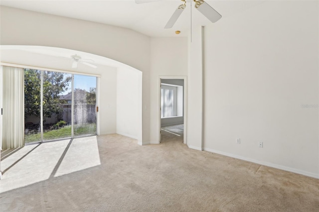 spare room featuring light carpet and ceiling fan