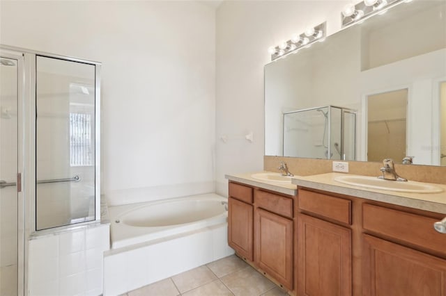 bathroom featuring plus walk in shower, vanity, and tile patterned floors