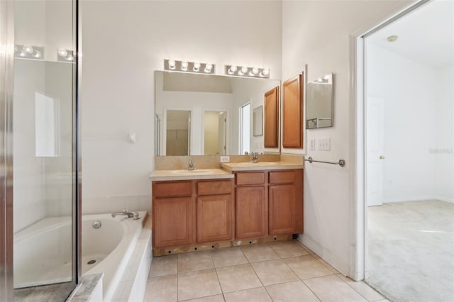 bathroom featuring tile patterned floors, vanity, and shower with separate bathtub