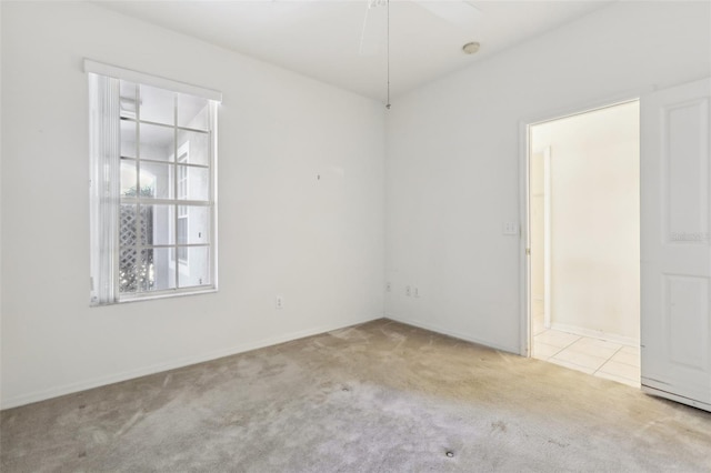 carpeted spare room with ceiling fan