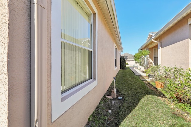 view of home's exterior with a lawn