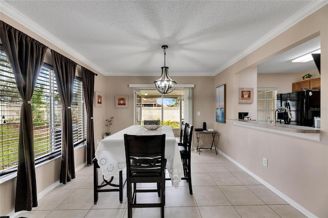 dining space featuring light tile patterned floors, crown molding, and a wealth of natural light