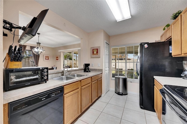 kitchen with a healthy amount of sunlight, light tile patterned floors, black appliances, and decorative light fixtures