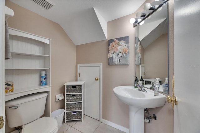 bathroom featuring tile patterned floors, vaulted ceiling, and toilet