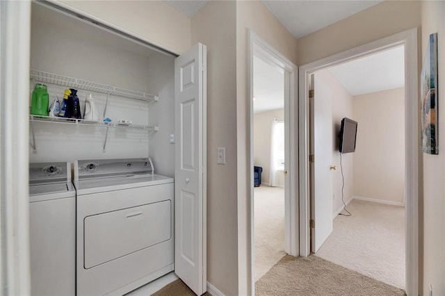 laundry area featuring washing machine and clothes dryer and light colored carpet