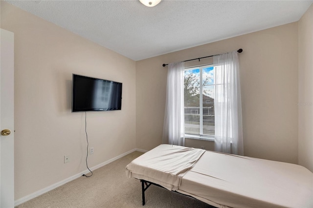 carpeted bedroom featuring a textured ceiling