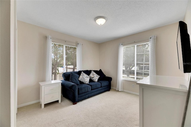 carpeted living room featuring a textured ceiling