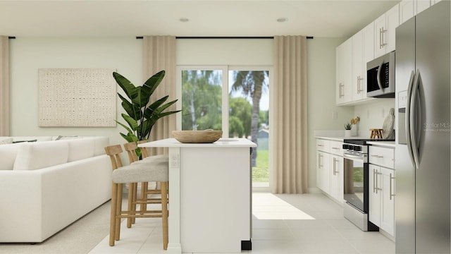 kitchen featuring a center island, white cabinets, light tile patterned floors, a kitchen bar, and stainless steel appliances