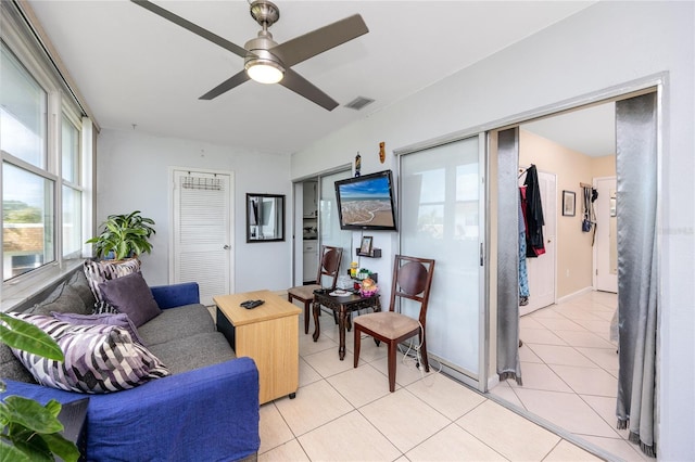 tiled living room featuring ceiling fan