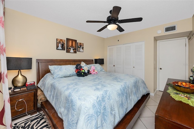 tiled bedroom with a closet and ceiling fan