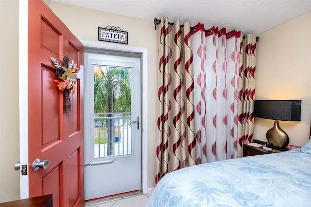 tiled bedroom with a textured ceiling