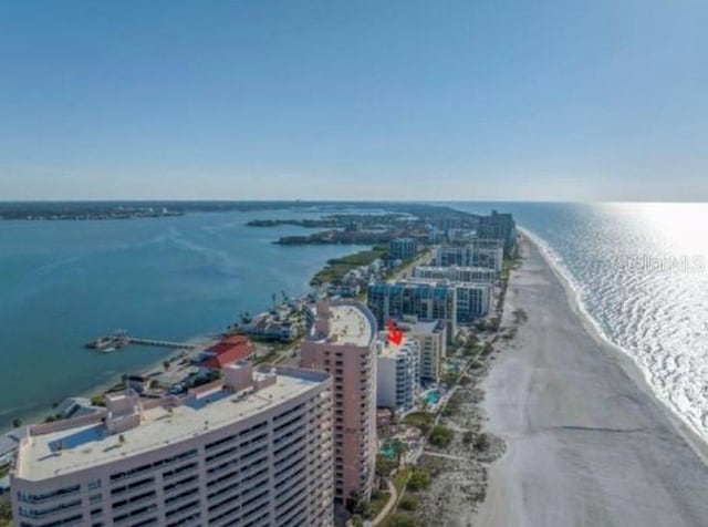 drone / aerial view featuring a beach view and a water view