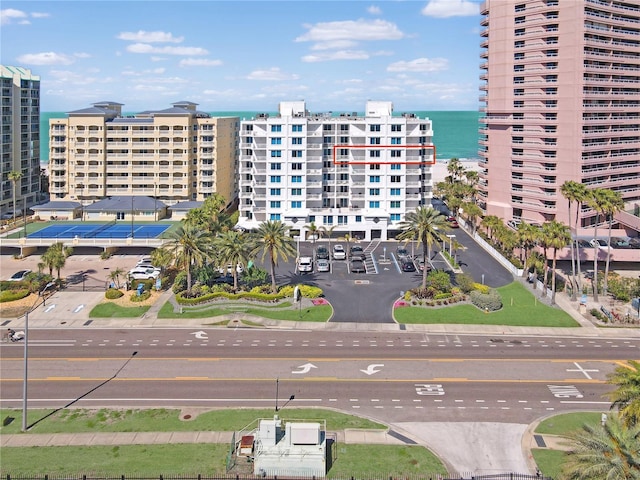 view of building exterior with a water view and a city view