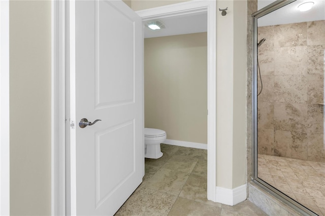 full bathroom featuring baseboards, a stall shower, toilet, and tile patterned flooring