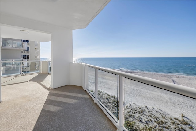 balcony with a beach view and a water view