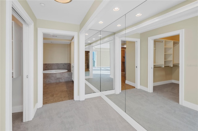 interior space with a spacious closet, a closet, carpet flooring, and recessed lighting