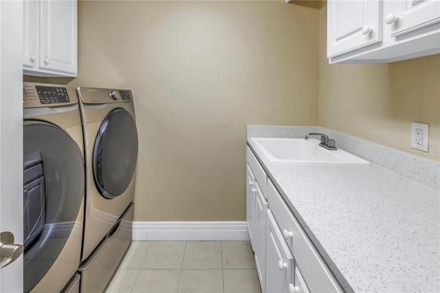 laundry area with a sink, cabinet space, light tile patterned floors, washing machine and dryer, and baseboards