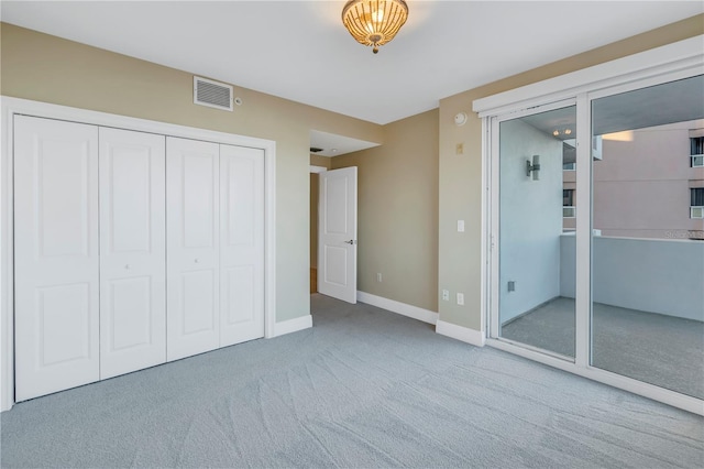 unfurnished bedroom with baseboards, visible vents, a closet, and carpet