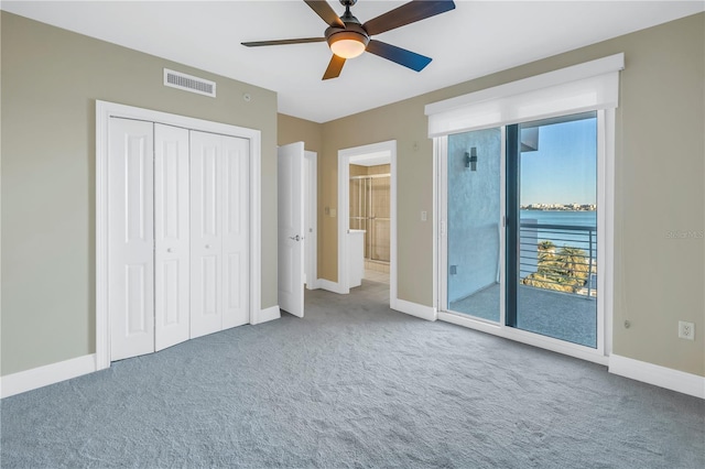 unfurnished bedroom featuring baseboards, visible vents, access to exterior, and carpet