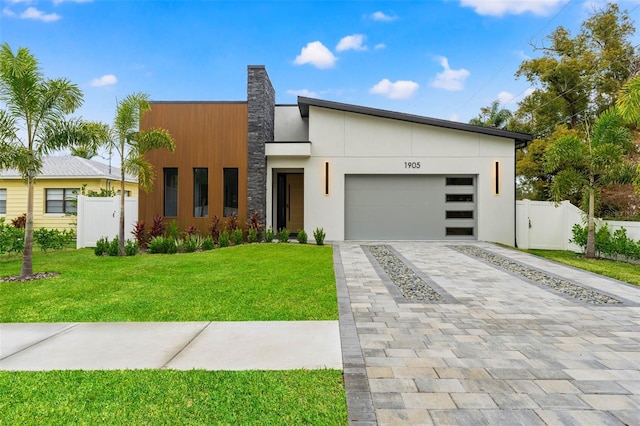 modern home with a front yard and a garage