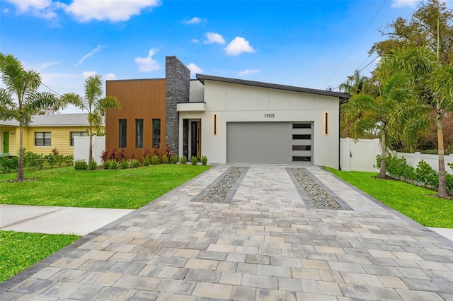 contemporary house with a front yard and a garage