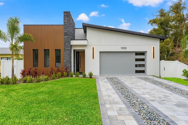 contemporary home with a garage and a front yard