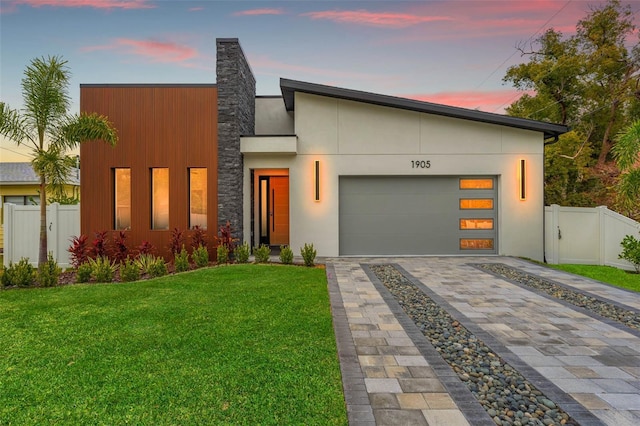 contemporary house with a garage and a yard