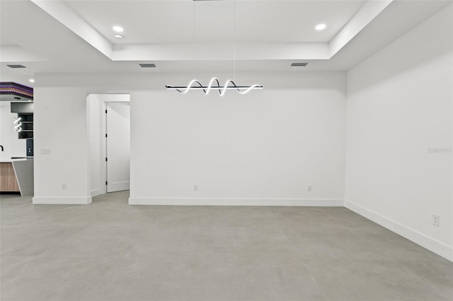 spare room featuring a tray ceiling