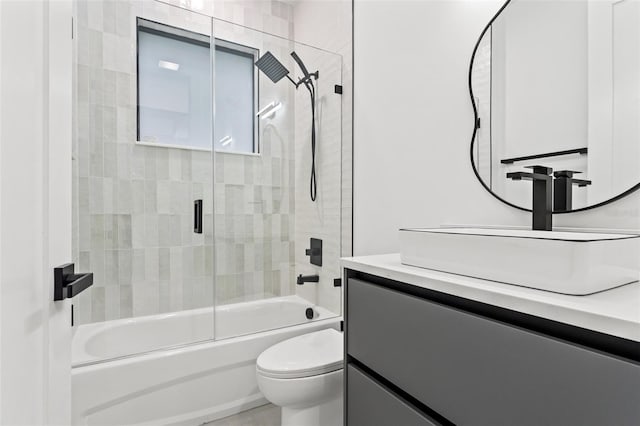 full bathroom featuring vanity, toilet, and enclosed tub / shower combo