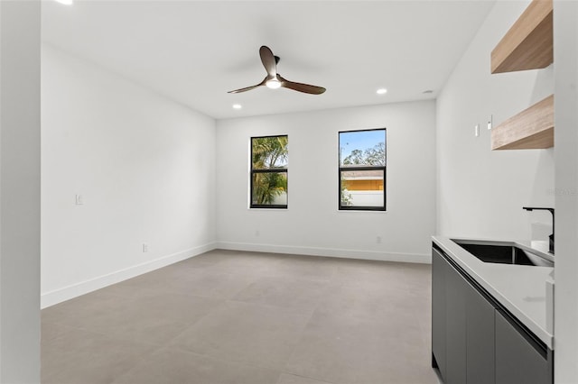 interior space featuring ceiling fan and sink