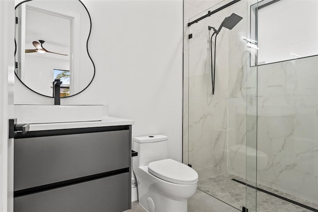 bathroom featuring vanity, ceiling fan, toilet, plenty of natural light, and an enclosed shower