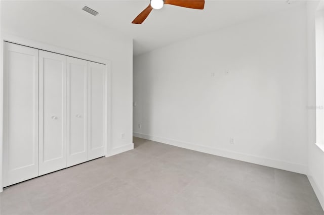 unfurnished bedroom with ceiling fan, a closet, and light tile patterned floors